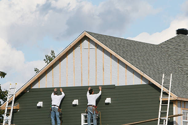 Professional Storm Damage Siding Repair technician working in Maynard, MA